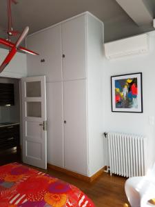 a bedroom with white cabinets and a red rug at Lux Kolonaki Apartment in Athens