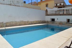 a swimming pool in a villa with a house at B&B Casa AriGiLi in Fuengirola