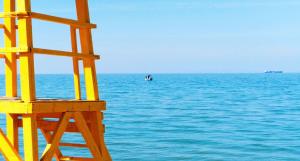 a yellow lifeguard tower sitting on top of the ocean at Hotel Avra in Perea