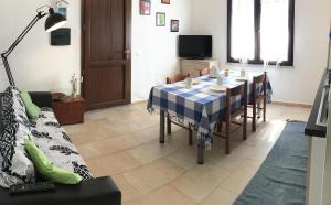 a living room with a dining room table and a couch at BnB Anacleto in Bassacutena