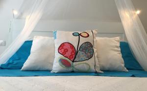 a bed with three pillows on top of it at BnB Anacleto in Bassacutena