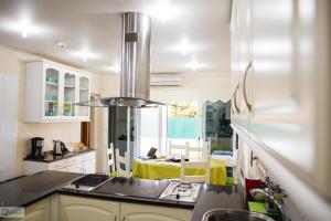 a kitchen with a sink and a stove top oven at Help Yourself Hostels - Carcavelos Coast in Carcavelos