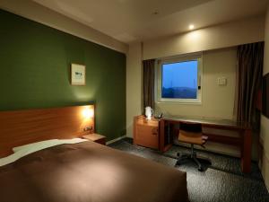 Łóżko lub łóżka w pokoju w obiekcie Candeo Hotels Kameyama