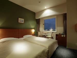 Postel nebo postele na pokoji v ubytování Candeo Hotels Sano