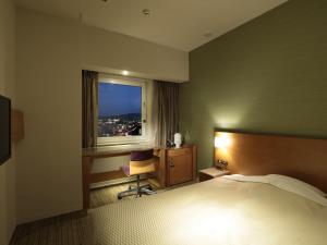 En eller flere senge i et værelse på Candeo Hotels Chino