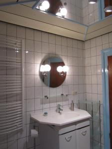 a bathroom with a sink and a mirror at Ferienhaus Zopfhäusl in Böbrach