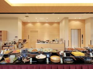 uma linha de buffet com muitos tipos diferentes de alimentos em Candeo Hotels Kikuyo Kumamoto Airport em Kikuyo
