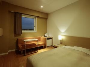 Vuode tai vuoteita majoituspaikassa Candeo Hotels Shizuoka Shimada