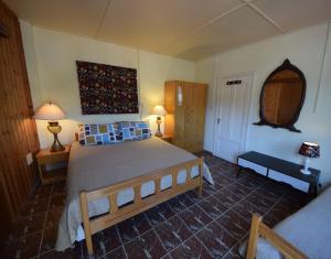 a bedroom with a large bed with blue pillows at Christys Palace Hotel in Pedoulas