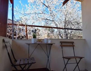 two chairs and a table in front of a window at Christys Palace Hotel in Pedoulas