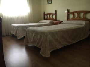 Postel nebo postele na pokoji v ubytování Hostal El Pinar