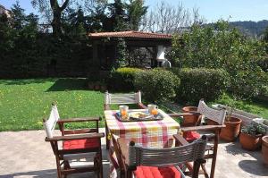 a table with four chairs and a gazebo at Beautiful house with garden in Rhodes in Ialysos