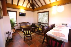 a dining room with a table and some chairs at La Estancia de la Pradera Cabana Fiba in Nobsa