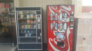 a soda vending machine next to a drink cooler at Howard Johnson by Wyndham Virginia Beach At The Beach in Virginia Beach
