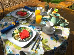 a table with plates of food and drinks on it at Hotel Casa Terra in Villa de Leyva
