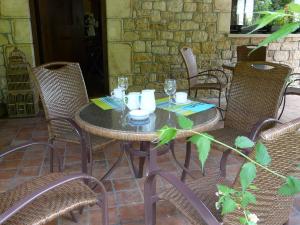 a table with chairs and a table with glasses on it at Casa Rural Haritzpe in Hondarribia