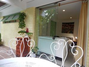 a patio with a table and chairs and a window at Casa São Conrado in Rio de Janeiro