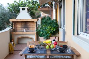 a table with a bowl of fruit on a balcony at Frini's View in Lefkada