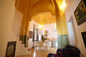 a kitchen and dining room with a table and chairs at Palazzo Salapolis - Luxury Apartments in Gallipoli