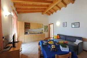 a living room with a blue table and a couch at Appartamento Ai Ruck in Limone sul Garda