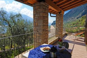 a table with a plate of food on a balcony at Appartamento Ai Ruck in Limone sul Garda