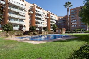 バルセロナにあるLodging Apartments Beach Penthouse near center with poolのアパートメントの建物の前にスイミングプールがあります。