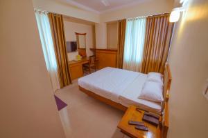 Postel nebo postele na pokoji v ubytování Pepper Residency