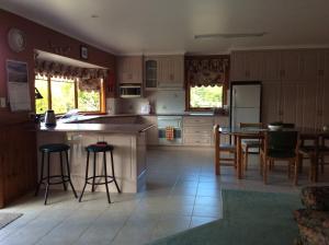 een keuken met een eiland en een tafel en stoelen bij Our Cottage in Ross