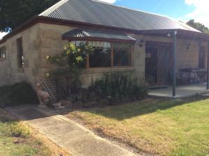 a small house with a garden in front of it at Our Cottage in Ross