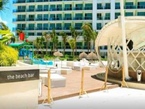 a hotel with a beach bar and a building at Azure Tropical Paradise in Manila