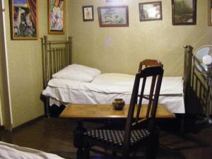 
a bed sitting in a room next to a wall at Tina's Homestay in Tbilisi City
