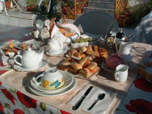 a table with a breakfast of tea and croissants at La Corte di Zaccaria in Mazara del Vallo