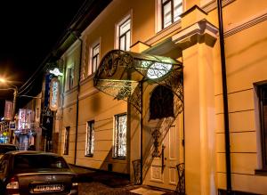 a building with a gate on a street at night at Pletnevskiy Inn in Kharkiv