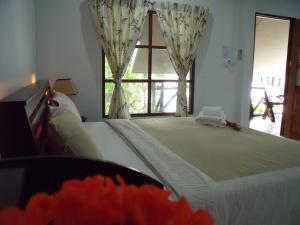 a bedroom with a large bed with a window at Squid Resort in Haad Chao Samran