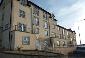 a large building with stairs on the side of it at Beautiful Seaview Penthouse Apartment in Bundoran