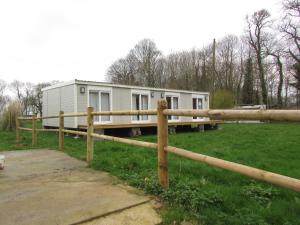 a mobile home in a field with a fence at Etretat's Motel in Étretat