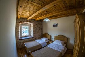 a bedroom with two beds and a window at Ducina Apartments in Milna