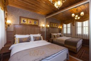 イスタンブールにあるFerman Konak Hotel-Special Categoryのベッドルーム1室(ベッド2台、シャンデリア付)