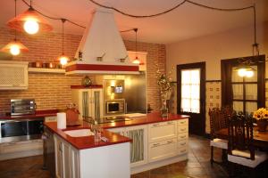 a kitchen with a sink and a stove top oven at Casa Rural Mendoza in Corral de Almaguer