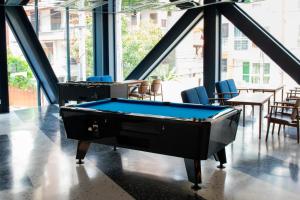 a pool table in a room with tables and chairs at Klub Hotel Bangkok in Bangkok +168 photos