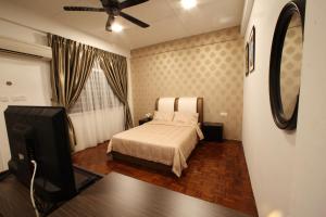 1 dormitorio con 1 cama y TV de pantalla plana en Come Inn Homestay 1380 en Miri