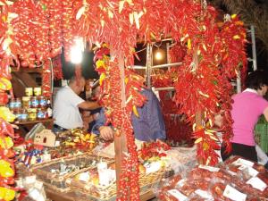 a group of people standing around a food stand at Villa dei Mercanti in Diamante