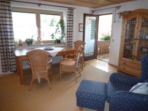 a dining room with a table and chairs at Landhaus Lotte in Halblech