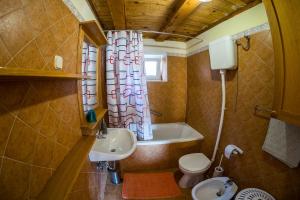 a bathroom with a sink and a toilet and a window at Ducina Apartments in Milna +35 photos