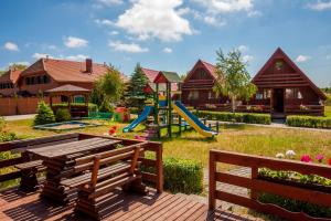 a park with a playground with a slide at Ośrodek Wczasowy Słoneczko in Dźwirzyno