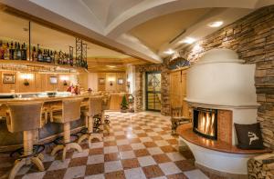 a kitchen with a fireplace in the middle of a room at Gut Berg Naturhotel in Sankt Johann im Pongau