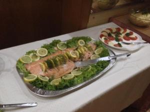 a platter of fish and vegetables on a table at Hostel im Osterzgebirge in Kurort Altenberg