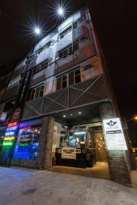 a building with a sign in front of it at night at 和平公獄監獄文旅 近東大門夜市 Peace Prison Cafe Inn in Hualien City