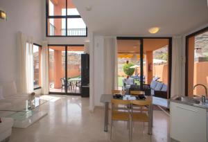 a kitchen and living room with a table and chairs at Casas de Tauro in La Playa de Tauro