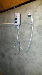 a cell phone is attached to the wall of a bathroom at Phu View Guesthouse in Pai